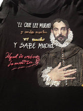 Close-up of Cervantes portrait with hand on chest and quote on T-shirt painted in textured color