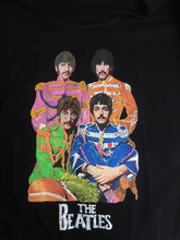  the Beatles’ hand-painted on a t-shirt, showing vivid color and detailed brushwork in their Sgt. Pepper uniforms.