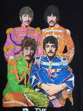  Close-up of the hand-painted Sgt. Pepper costumes on a t-shirt, highlighting textured brushstrokes and permanent vibrant colors.