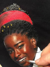 Hand of the artist Artist painting Amanda Gorman portrait on a custom T-shirt