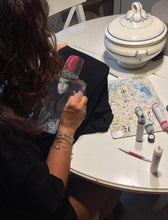 Artist painting Erykah Badu T-shirt by hand – permanent 3D colors in progress on unique wearable artwork