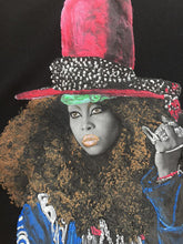 Close-up of hand-painted Erykah Badu image painted  on T-shirt – colorful painted relief detail and expressive afro-soul style
