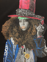 Close-up of hand-painted Erykah Badu portrait on T-shirt – colorful relief detail and expressive afro-soul style