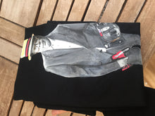 Folded personalized T-shirt laid on a table featuring a painted portrait of a customer’s husband