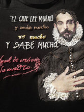 Close-up of Cervantes portrait with hand on chest and quote "El que lee mucho..." painted in textured color