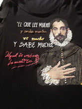 Close-up of Cervantes face with hand on chest and quote "El que lee mucho..." painted in textured color
