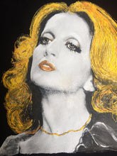 Textured detail of Mina’s face painted on t-shirt