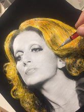 Detail of artist’s hand creating hand-painted Mina t-shirt – unique art piece