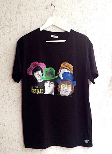 Full view of a hand-painted t-shirt featuring vibrant, colorful portraits of The Beatles’ faces in expressive pop art style.