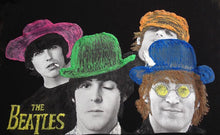 Close-up of the Beatles’ hand-painted faces on a t-shirt, showing vivid colors and textured brushwork.