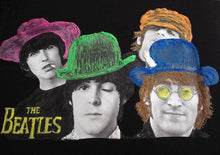 Close-up of the 4 Beatles’ hand-painted faces on a t-shirt, showing vivid colors and textured brushwork.