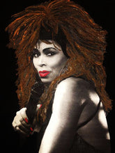 Close-up of a hand-painted artistic portrait of Tina Turner on a black t-shirt, highlighting detailed brushwork and vibrant colors.