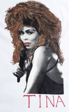 Artistic hand-painted close-up of Tina Turner’s face on a white t-shirt, showcasing fine brush details and vivid design.